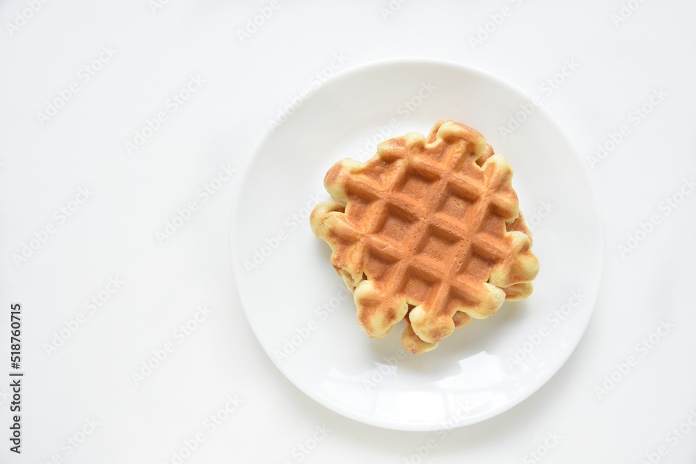 Viennese waffles on a white plate. Delicious waffles for breakfast. Viennese waffles on a white plate. Delicious waffles for breakfast.