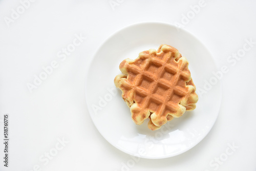 Viennese waffles on a white plate. Delicious waffles for breakfast.