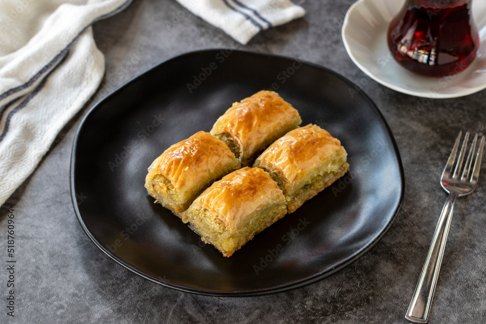 Turkish baklava. Baklava slices with pistachio on a dark background. Bakery products. side view. Turkish cuisine. Close-up. Turkish baklava. Baklava slices with pistachio on a dark background. Bakery products. side view. Turkish cuisine. Close-up.