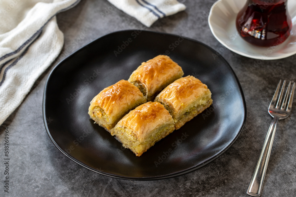 Turkish baklava. Baklava slices with pistachio on a dark background. Bakery products. side view. Turkish cuisine. Close-up.