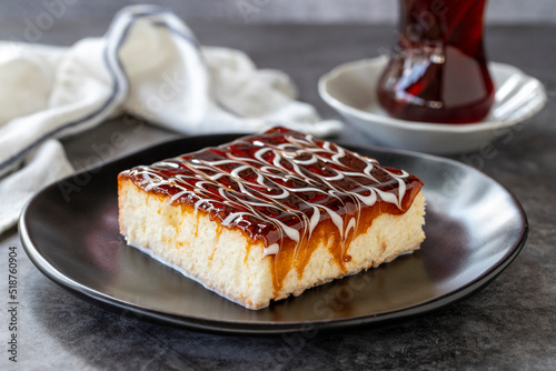 Trilece dessert. Slice of dessert with caramel and milk on a dark background. Bakery products. side view. Close-up. photo