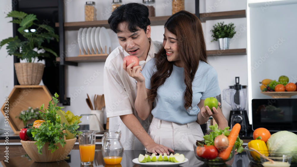 asian couple cooking at kitchen