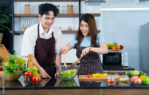 asian couple cooking at kitchen © Thongden_studio