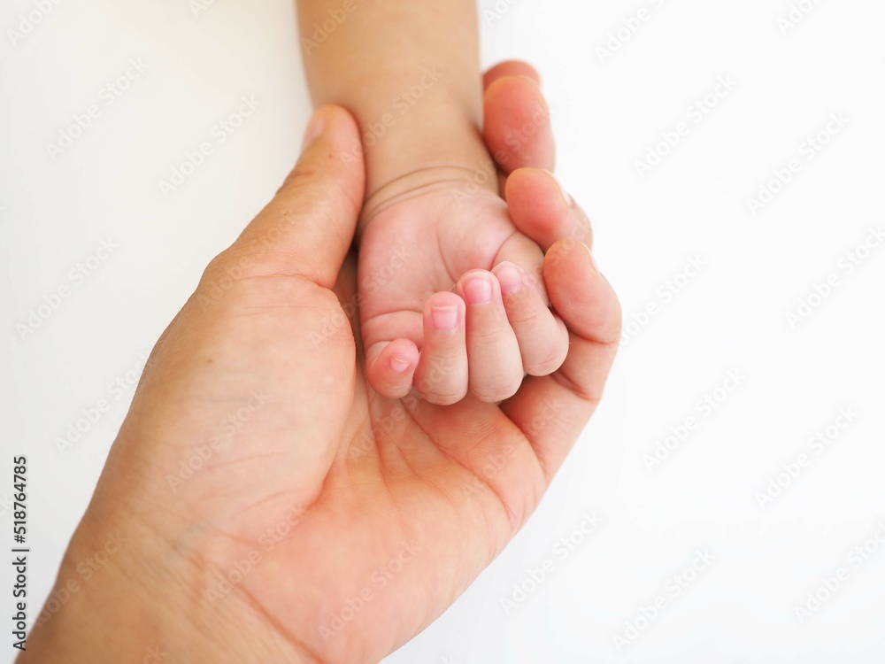 Newborn baby grasping her mother's finger. Concept of child care, feeling safe. closeup photo, blurred. Newborn baby grasping her mother's finger. Concept of child care, feeling safe. closeup photo, blurred.