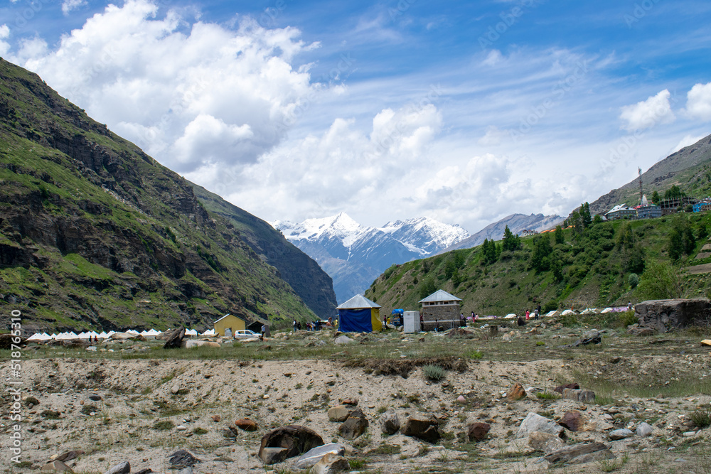 White dome structures and huts are settled in a small mountain village of lahaul valley. Beautiful Sissu village surrounded by huge barren and snow covered mountains in Himachal Pradesh, India.