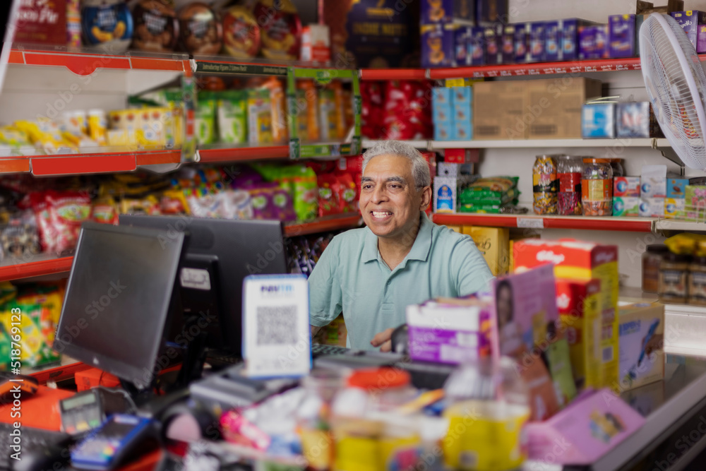 Happy man working as a cashier at supermarket