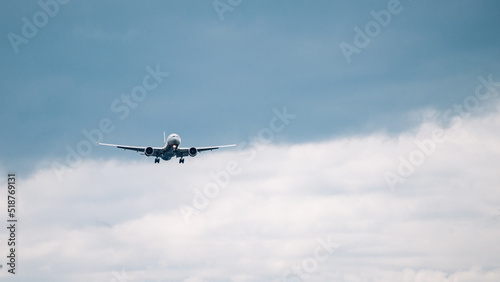 Passenger plane comes in for landing in cloudy weather.