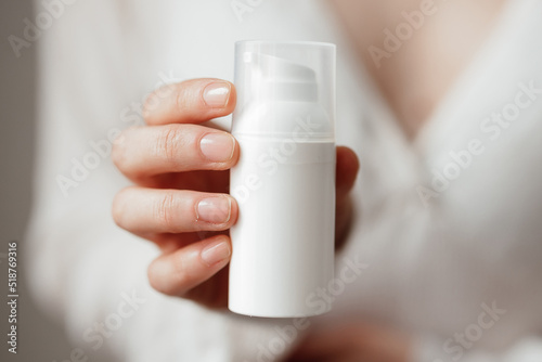 Cream skin care hands. Close-up woman holding cream for hands. Woman applying hand cream. Girl holding tube with skin care produc in front of camera.View from front.SPF protection.Skin healthy.
