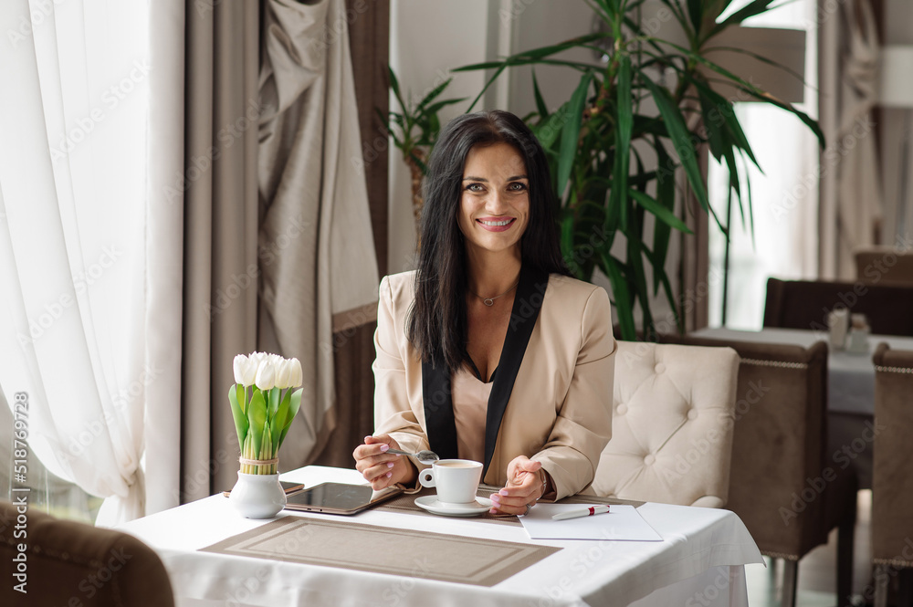 Successful buseness woman is drinking coffee during working day at the cafe Successful buseness woman is drinking coffee during working day at the cafe