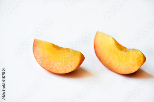 Sliced fresh peaches on a white background.