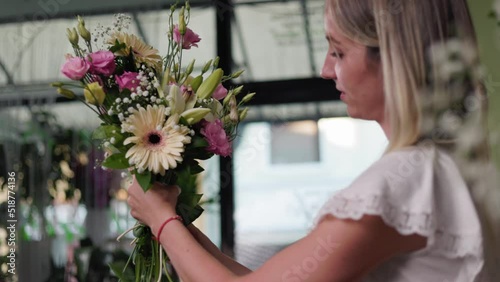 Floral artist working in flower shop. Floristry creating flower arrangement. Small woman business concept, self employed.

