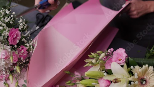 Floral artist working in flower shop. Floristry creating flower arrangement. Small woman business concept, self employed.
