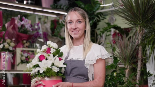 Portrait Of A Beautiful Girl At Her Flower Shop Holding A Plant, Flower. Small business, florst, entrepreneurship concept. 