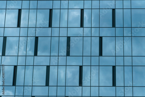 High-rise modern building made of blue glass. An unusual glass skyscraper. The concept of building modern buildings with futuristic design for business and a happy life.