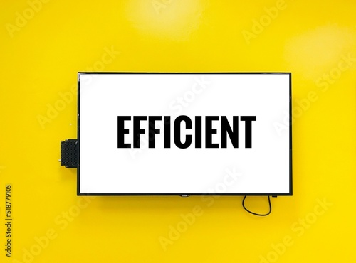 Efficient note on television against yellow wall