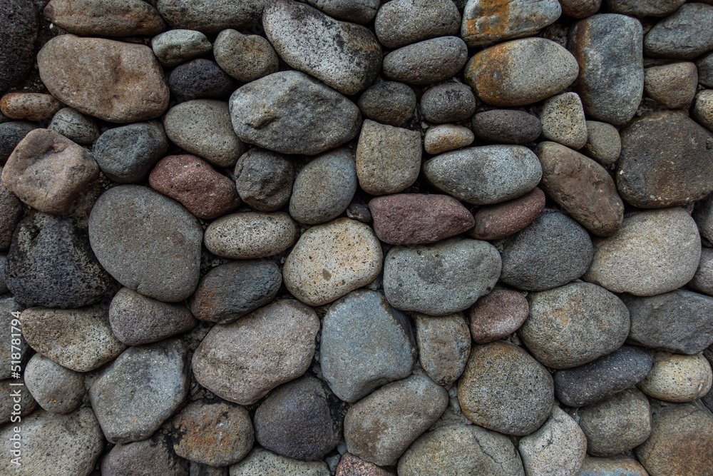A close up view of a group of oval-shaped rocks with dark pastel colors A close up view of a group of oval-shaped rocks with dark pastel colors