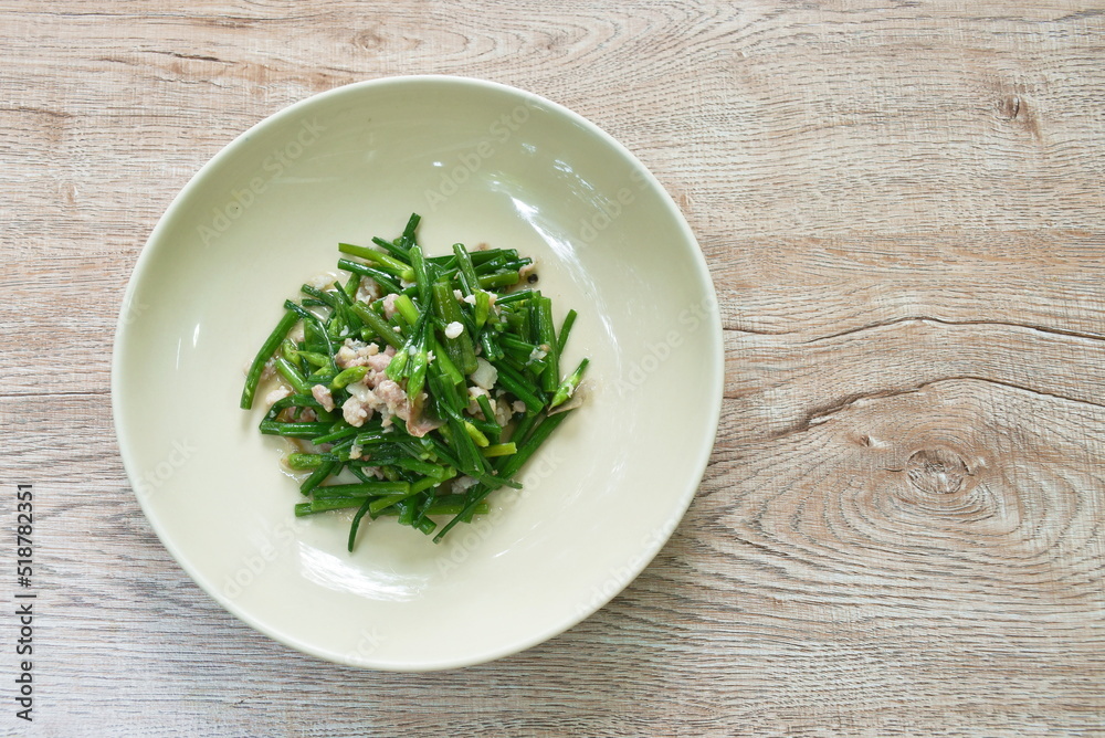 stir fried slice garlic chives with chop pork on plate stir fried slice garlic chives with chop pork on plate