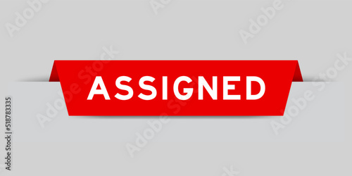 Red color inserted label with word assigned on gray background
