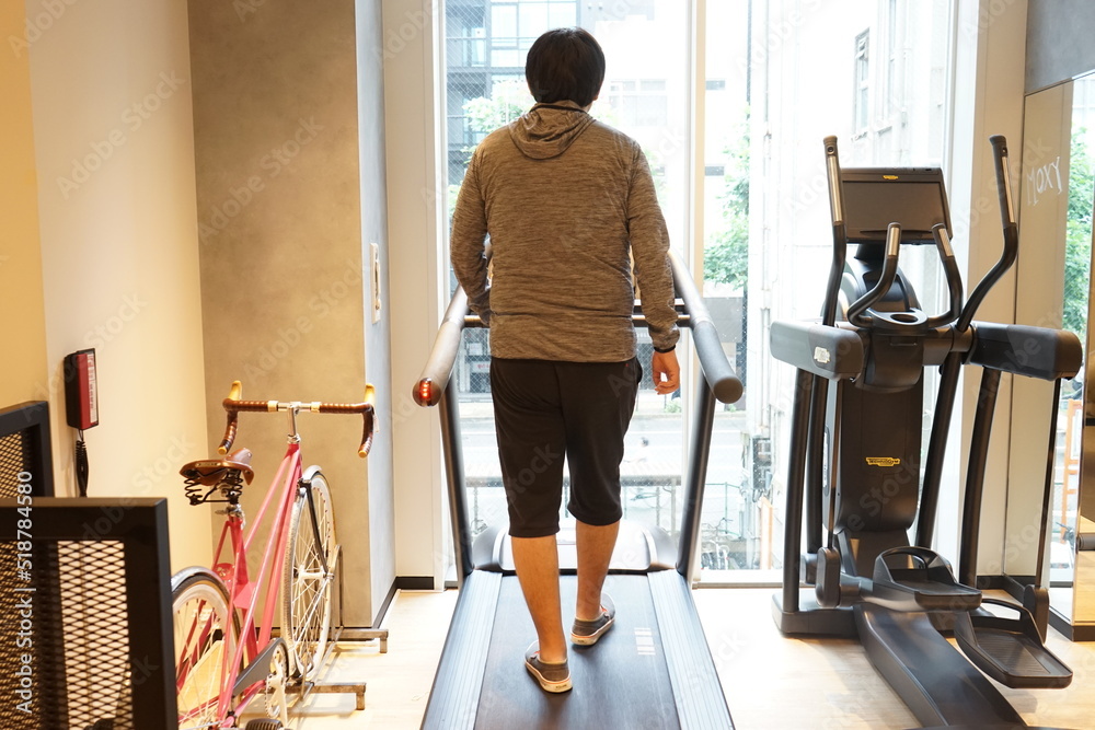 Overweight Fitness Man Running on a Treadmill at Gym, Fat fitness men exercising at fitness gym. Man diet lifestyle concept to reduce belly - 運動をする男性 バイクエクササイズ