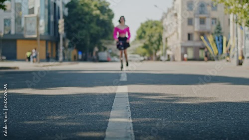 Wallpaper Mural playful girl enjoys summer and rides a scooter through the park and city streets. Torontodigital.ca
