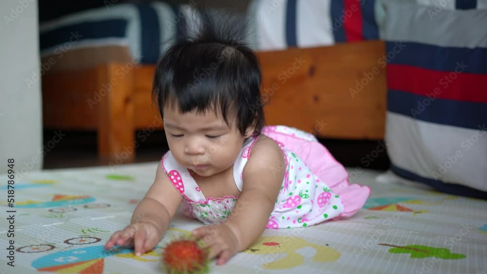 A cute caucasian infant baby is laying and playing on form mattress in the living room. Baby portrait eye focus. People 4k footage. A cute caucasian infant baby is laying and playing on form mattress in the living room. Baby portrait eye focus. People 4k footage.