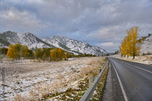 Russia. The South of Western Siberia, the Altai Mountains. The first autumn snow on the Chui highway near the village of Shebalino, surrounded by snow-capped mountains. photo