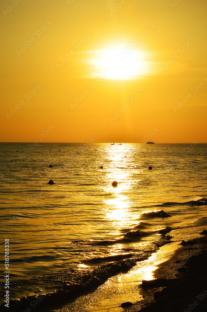the sea at sunset. nature in the evening. dark water. summer vacation. background for the design. orange light.