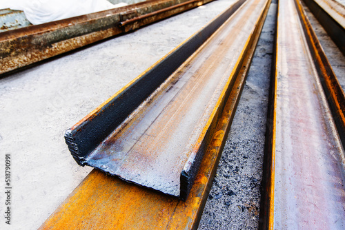 Corroded metal beams are located at the construction site. Foreground. selective focus