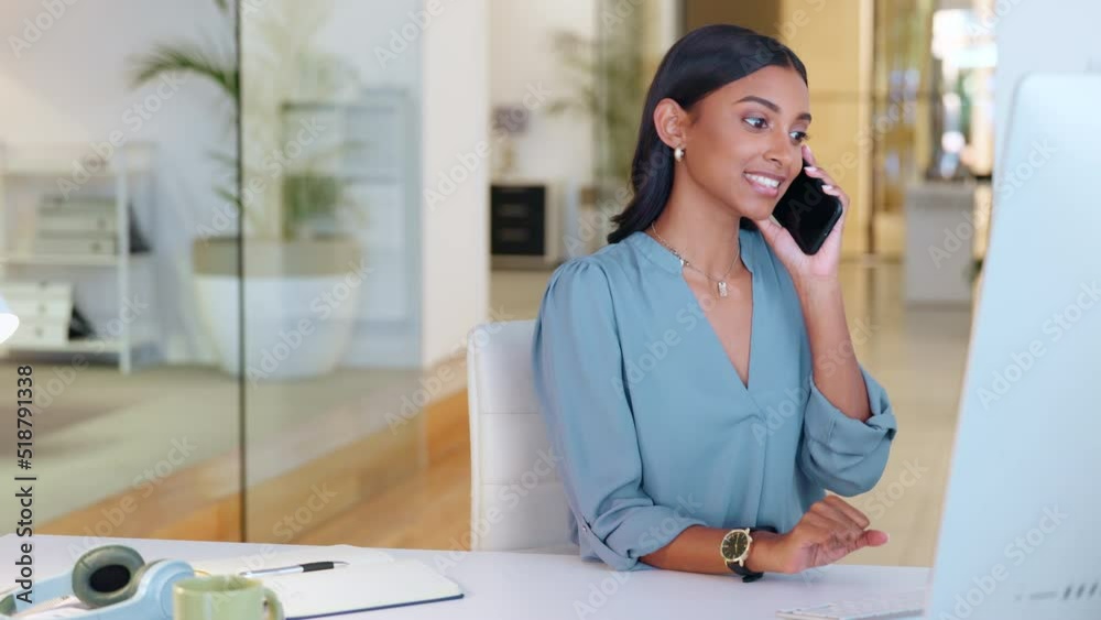 Young events coordinator talking with suppliers and caters on her phone to organize delivery. Confident female administrative assistant planning dates and venues on her computer in the office
