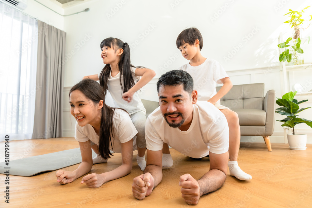 Young asian parents with child meditating at home isolated in room. Family, sport, yoga concept. Young asian parents with child meditating at home isolated in room. Family, sport, yoga concept.