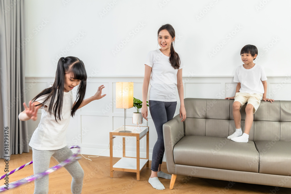 Young asian parents with child meditating at home isolated in room. Family, sport, yoga concept. Young asian parents with child meditating at home isolated in room. Family, sport, yoga concept.