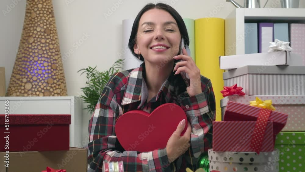 The young charming attractive woman is preparing gifts at home. Portrait of happy female closeup The young charming attractive woman is preparing gifts at home. Portrait of happy female closeup