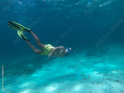 underwater man snorkeling in the sea withcrystal-clear waters concept of holiday relax summer beach diver in the sea 