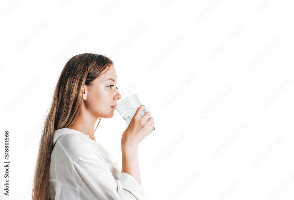 Asian girl with purple drinks water from a plastic bottle on a white isolated background. Generation Z. The concept of thirst Asian girl with purple drinks water from a plastic bottle on a white isolated background. Generation Z. The concept of thirst