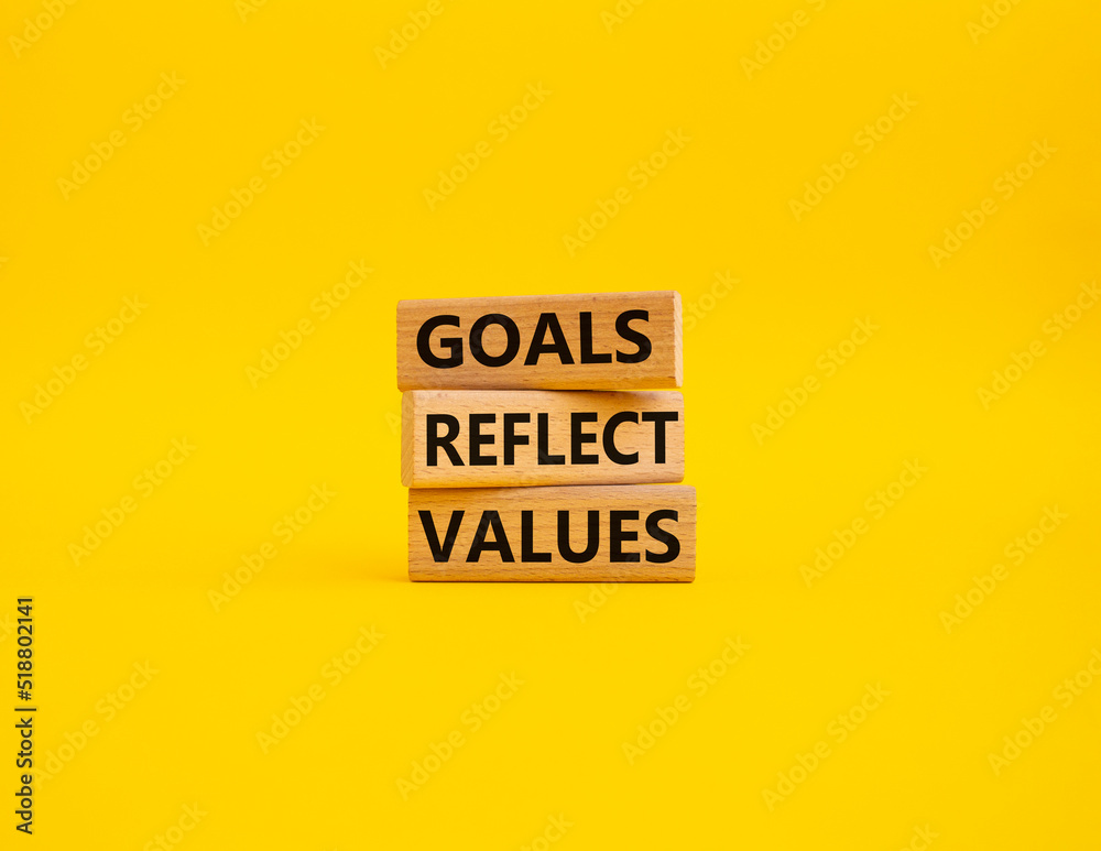 Goals reflect values symbol. Concept words Goals reflect values on wooden blocks. Beautiful yellow background. Business and Goals reflect values concept. Copy space Goals reflect values symbol. Concept words Goals reflect values on wooden blocks. Beautiful yellow background. Business and Goals reflect values concept. Copy space