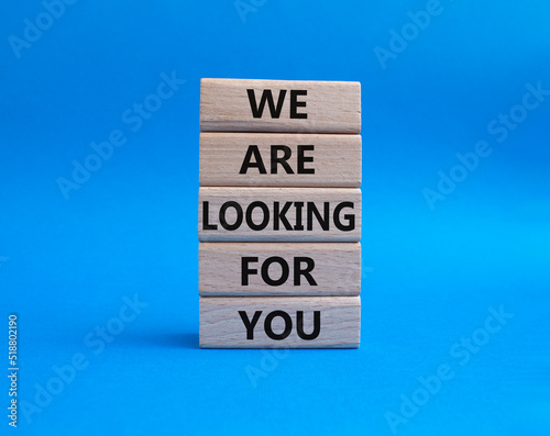 We are looking for you symbol. Wooden blocks with words We are looking for you. Beautiful blue background. Business and We are looking for your concept. Copy space.