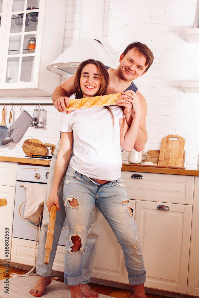 young caucasian couple together having fun on kitchen, woman pregnant, lifestyle people concept young caucasian couple together having fun on kitchen, woman pregnant, lifestyle people concept