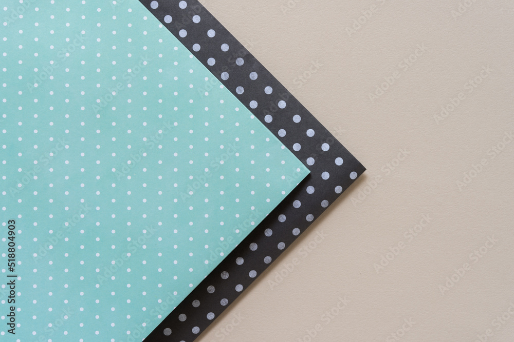 folded scrapbook paper in green and gray on beige