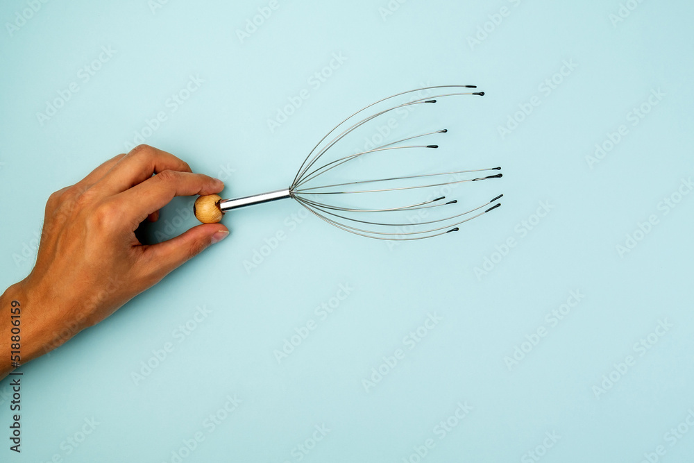 Manual massage for the head device. Allows you to relax and get rid of stress. Blue background Manual massage for the head device. Allows you to relax and get rid of stress. Blue background