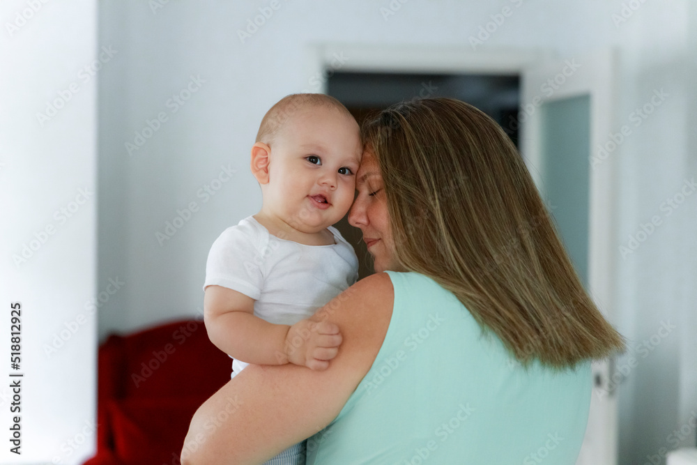 Happy mother with her cute little baby in her arms Happy mother with her cute little baby in her arms
