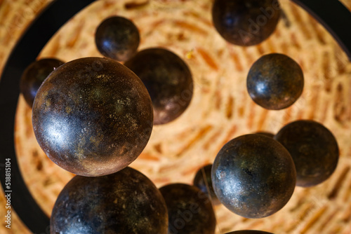 black balls in a circle with bokeh photo