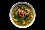Thai food chicken green curry on black isolated background. top view