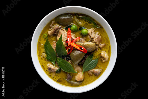Thai food chicken green curry on black isolated background. top view
