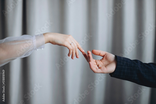 The bride reaches out to the groom's hand © Sheremetio