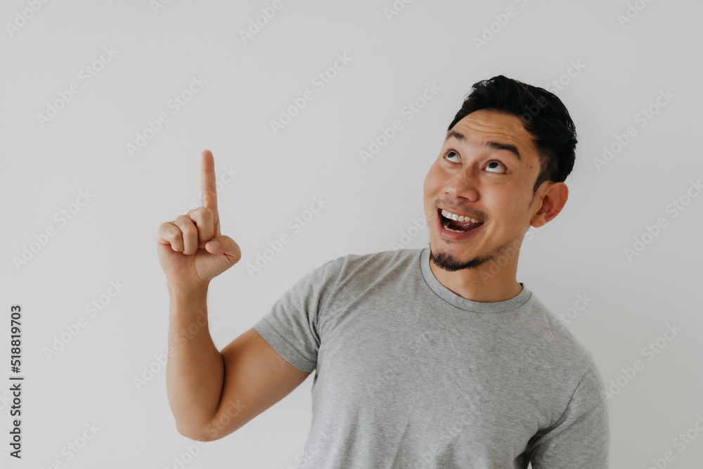 Asian man surprise and curious face because of something is falling down. Asian man surprise and curious face because of something is falling down.