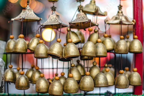 Small brass bells made as souvenirs are sold in the old Chinese market, Ban Chak Ngaew, Chonburi Province, Thailand.