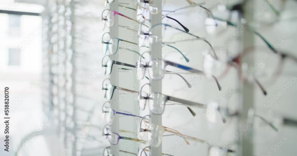 Fashionable corrective eye glasses on a shelf of an optical shop for clients to choose from. Spectacles or prescription lenses with frames at an optometry clinic. A rack full of stylish eyewear