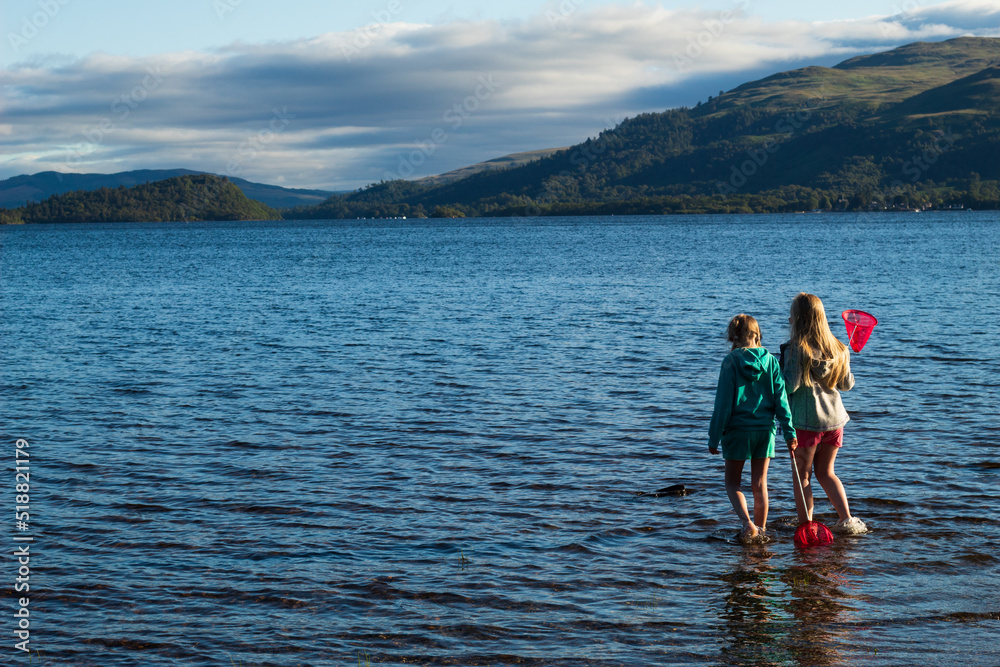 Children having fun playing on Loch Lomond Beech Children having fun playing on Loch Lomond Beech