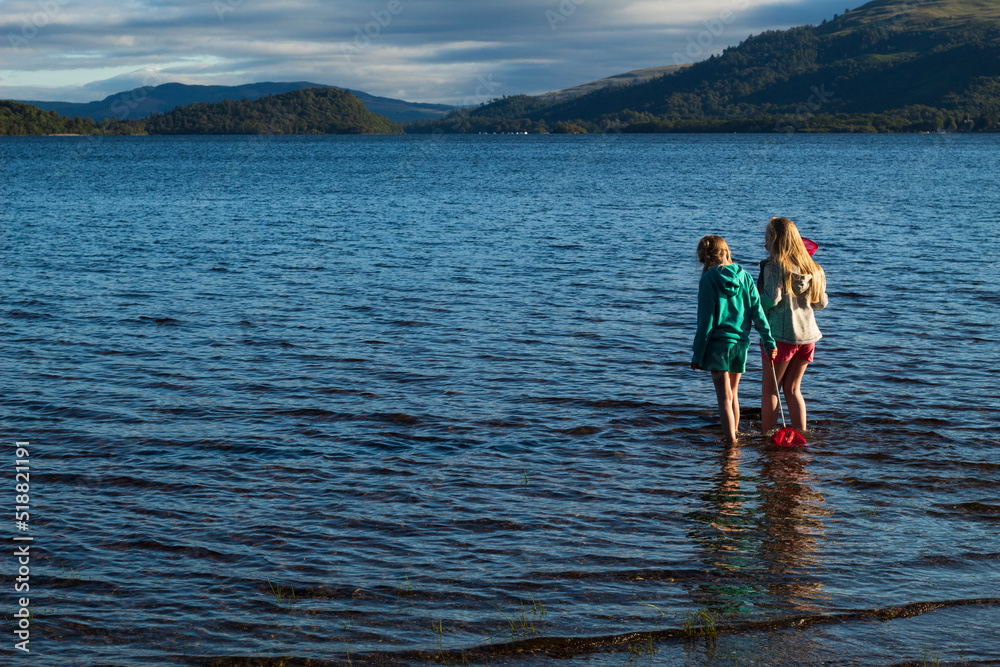 Children having fun playing on Loch Lomond Beech Children having fun playing on Loch Lomond Beech