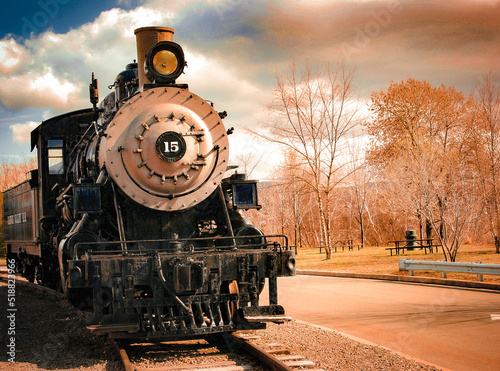 old steam train approaching in the fall
